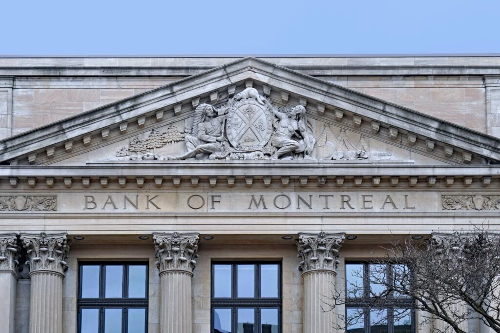 Stone coat of arms of Bank of Montreal on traditional classical style building. Photo: Shutterstock
