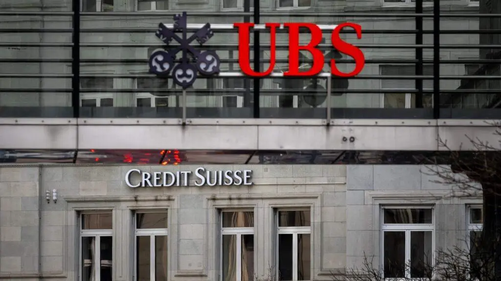 UBS and Credit Suisse office logos are displayed side by side, as the two banks continue their integration process. London, England. PHOTO: Cate Gillon/Getty Images