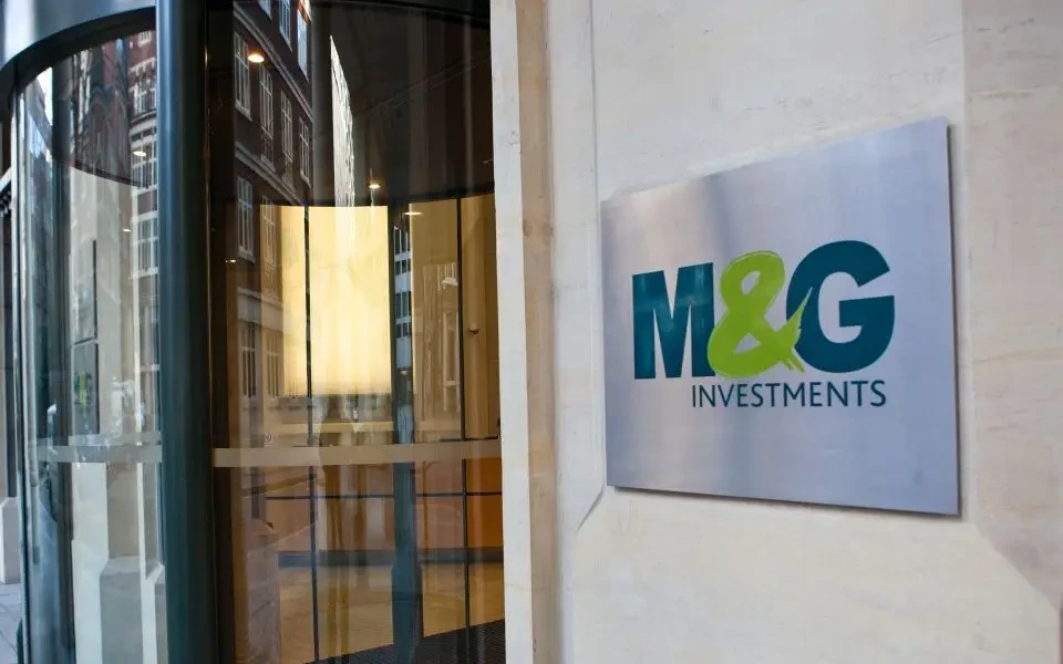 M&G's logo shines proudly outside their office, reflecting their strong profits and resilient business model mentioned in the article. PHOTO: Shutterstock