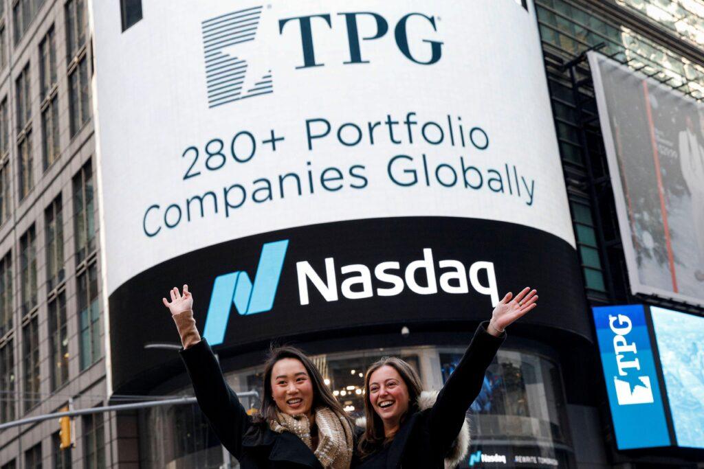 Employees of Private-equity firm TPG, celebrate their company's IPO outside the Nasdaq Market site in Times Square in New York City, U.S., January 13, 2022. Photo: Getty Images