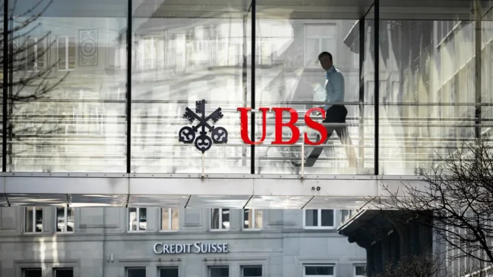 UBS: Navigating Change - A worker walks towards UBS headquarters, symbolizing the ongoing transformation amid industry challenges. PHOTO: AlanaA/Shutterstock
