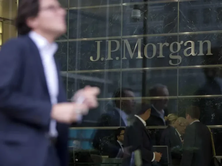 A banker walking past the JP Morgan London Office in Canary Wharf. PHOTO: Neil Hall/Reuters