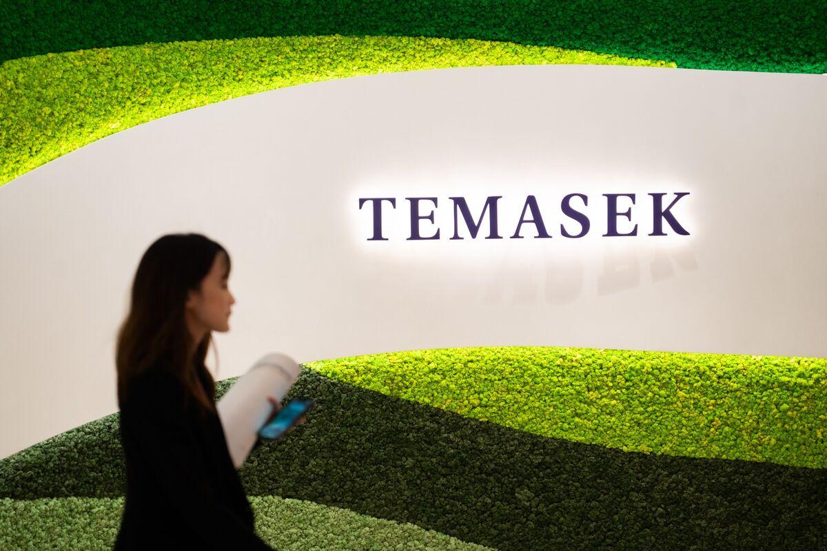 Employee walking across signage of Temasek. PHOTO: Shutterstock